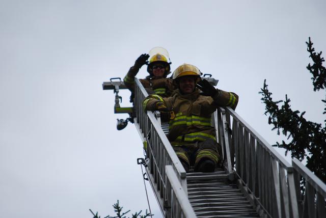 Firefighters' Branden Sisca and Matt Bean at the top of Ladder 77.